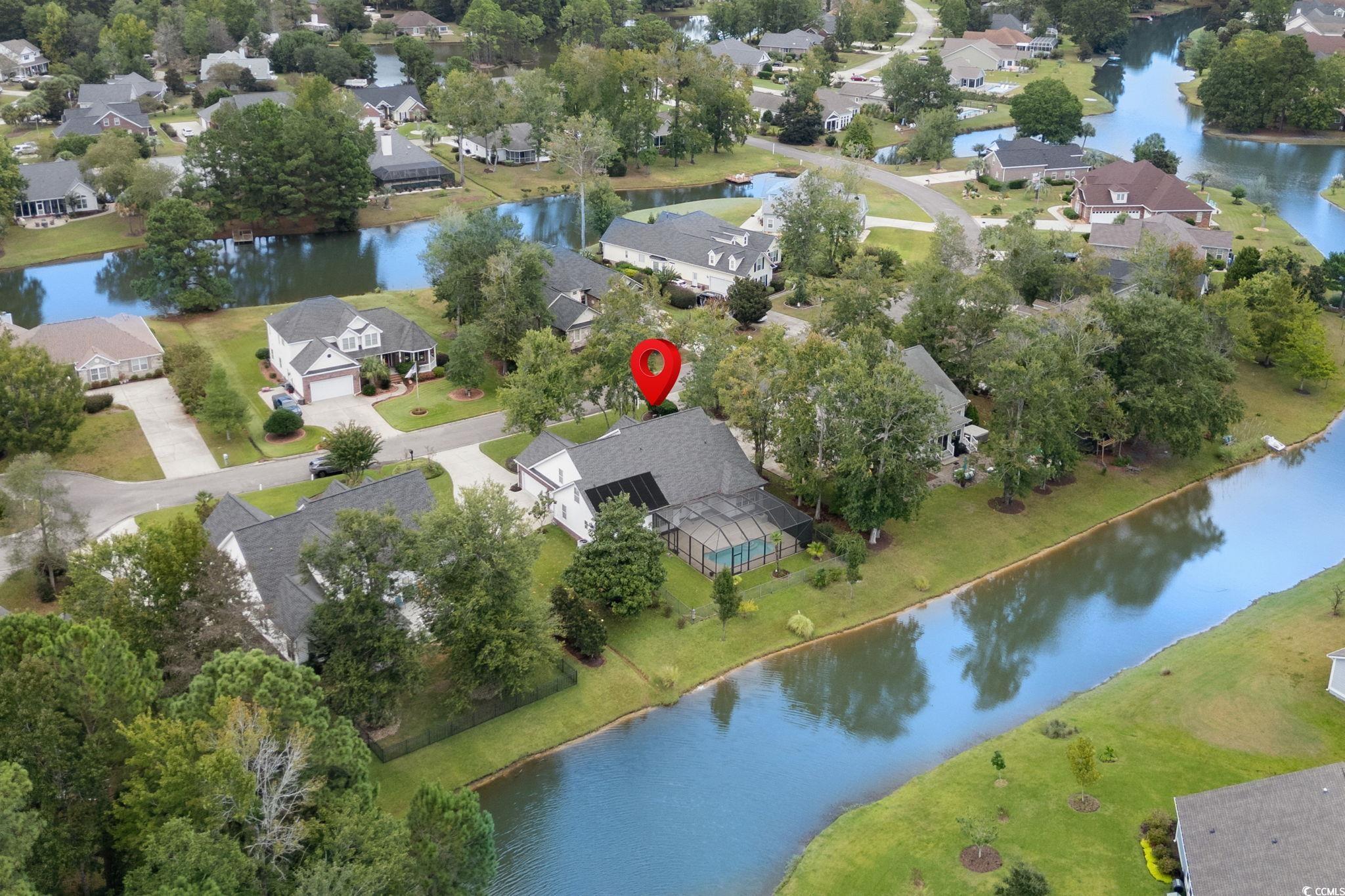 613 Broad River Road Myrtle Beach, SC 29588 - Photo 4 of 40 Aerial view of property and surrounding area featuring a large body of water and nearby suburban area