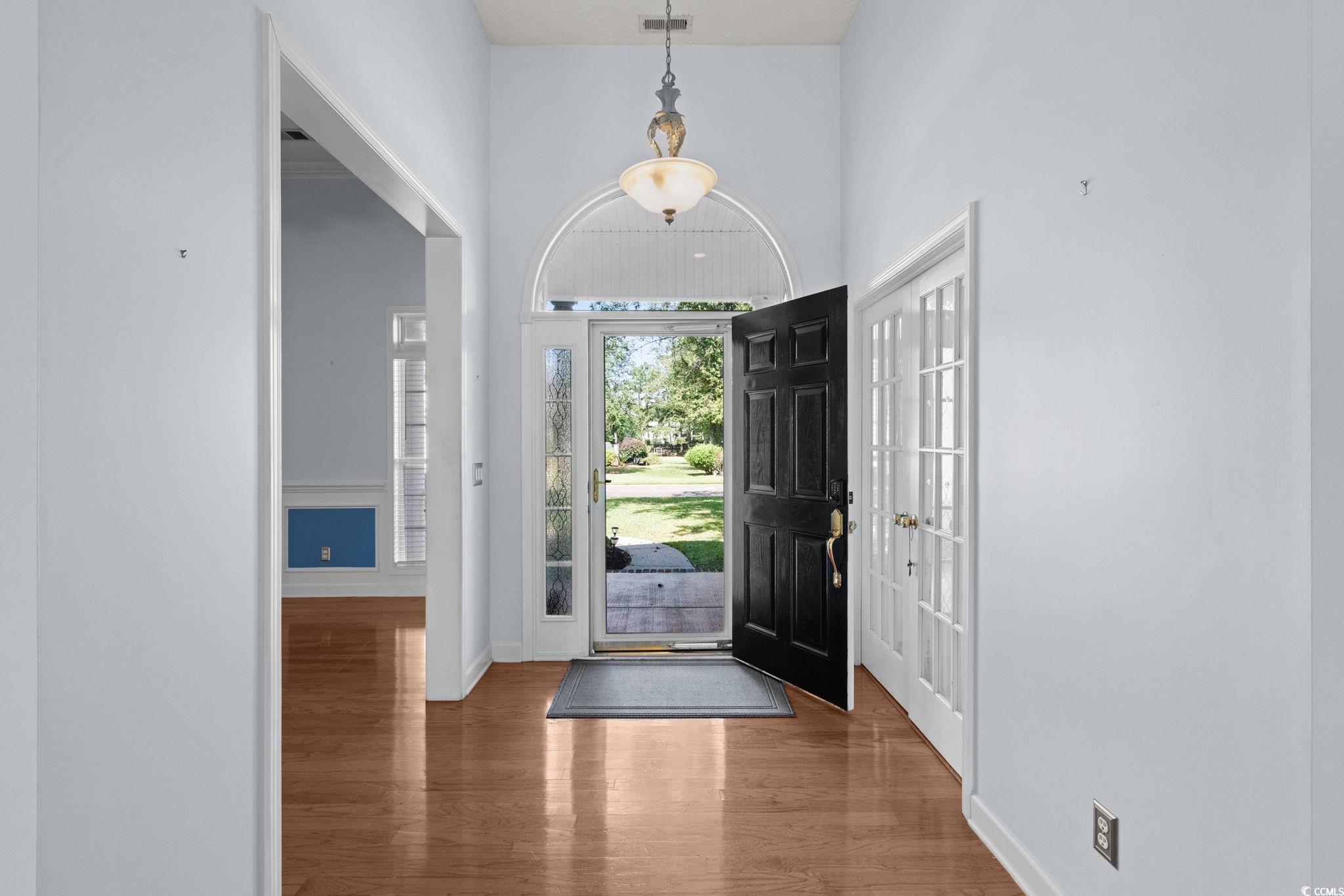 613 Broad River Road Myrtle Beach, SC 29588 - Photo 8 of 40 Entryway featuring wood finished floors and a high ceiling
