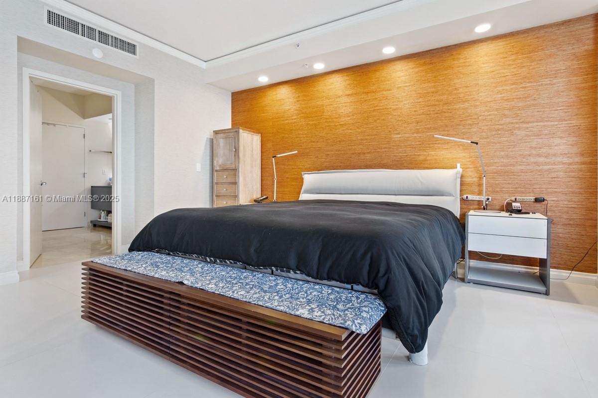 18001 Collins Avenue, Unit 2209 Sunny Isles Beach, FL 33160 - Photo 13 of 27 a bedroom with a large bed and a chandelier