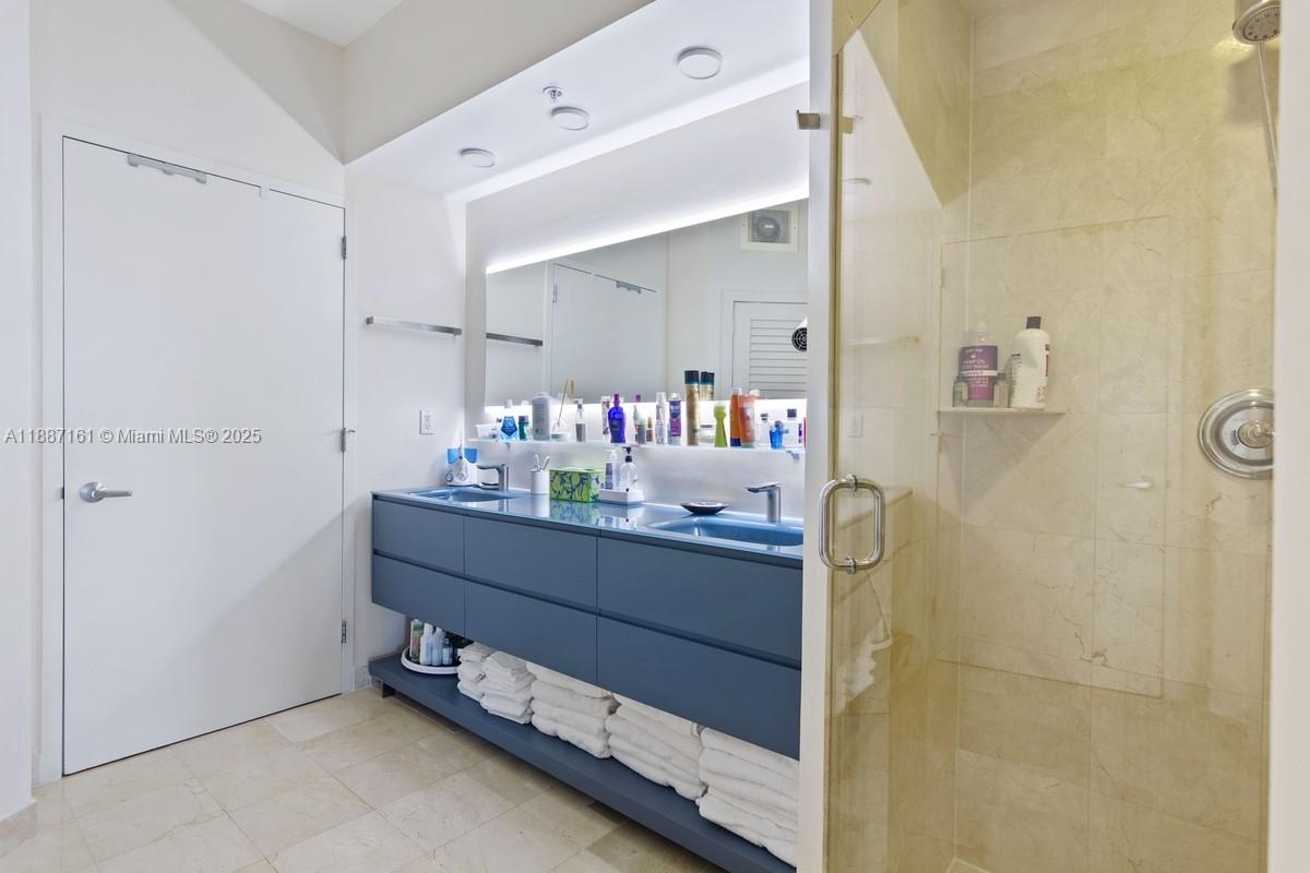 18001 Collins Avenue, Unit 2209 Sunny Isles Beach, FL 33160 - Photo 14 of 27 a room with painting and a table