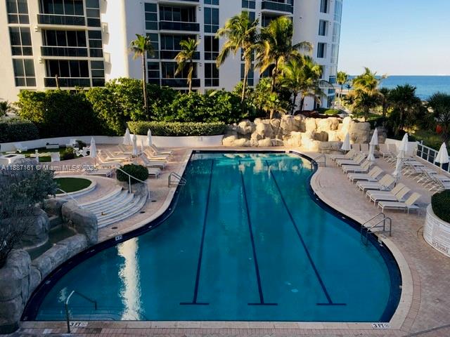 18001 Collins Avenue, Unit 2209 Sunny Isles Beach, FL 33160 - Photo 18 of 27 a view of a swimming pool with outdoor seating and plants