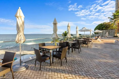 a view of a patio with table and chairs