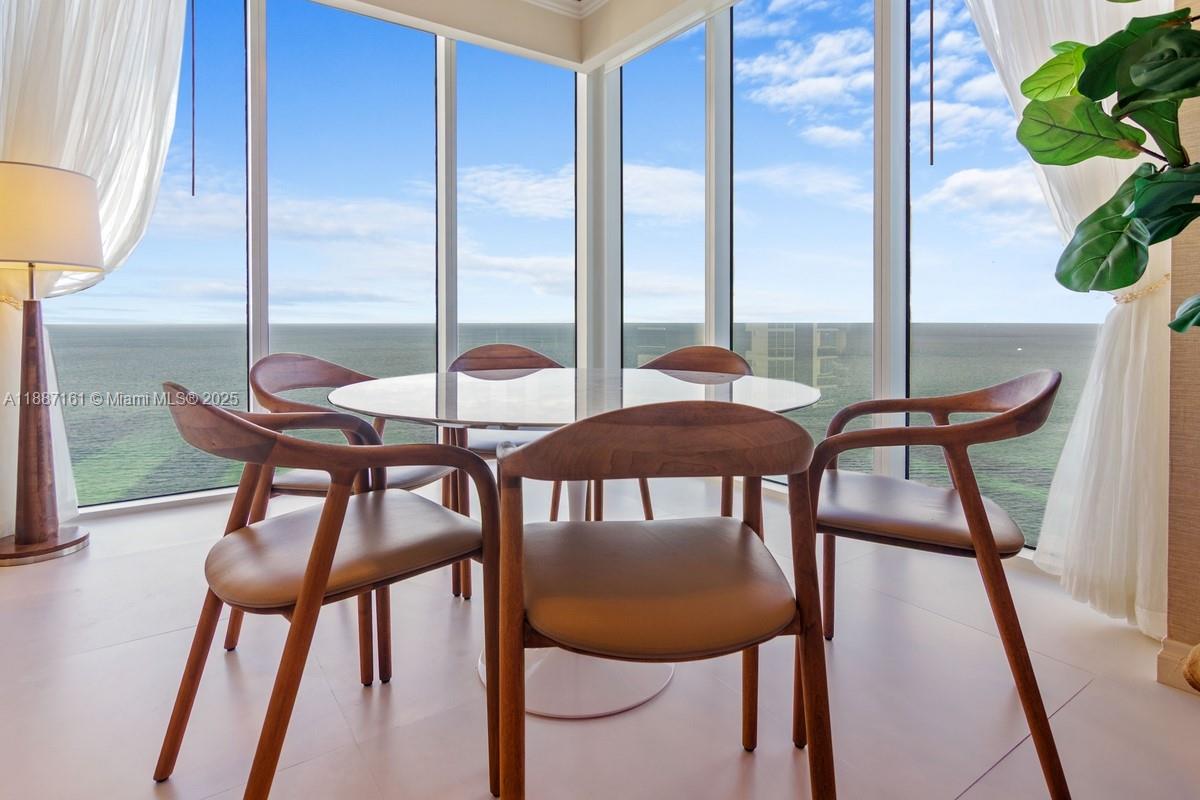 18001 Collins Avenue, Unit 2209 Sunny Isles Beach, FL 33160 - Photo 7 of 27 a view of a dining room with furniture and a window