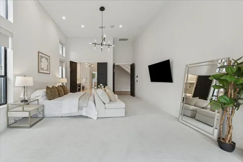 a spacious en suite bathroom with a granite countertop sink a mirror a vanity and a bathtub