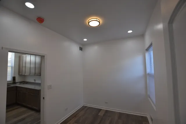 a view of an empty room with a kitchen