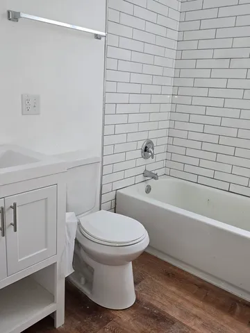 a bathroom with a toilet and a bathtub