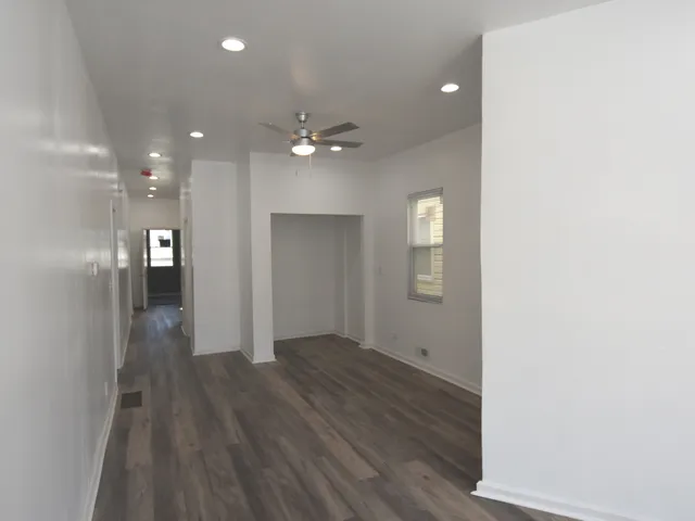 a view of a hallway with wooden floor