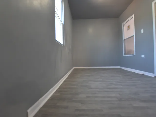 a bathroom with a toilet a sink a mirror and shower