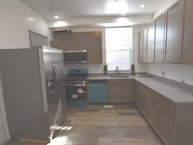 a kitchen with a sink stainless steel appliances and cabinets
