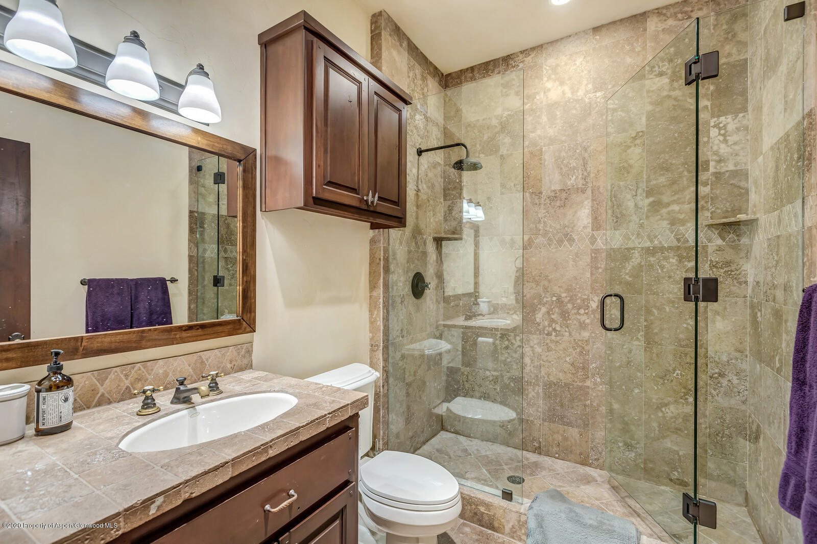 160 Red Rock Road Basalt, CO 81621 - Photo 19 of 45 a bathroom with a granite countertop sink toilet a mirror a shower and vanity