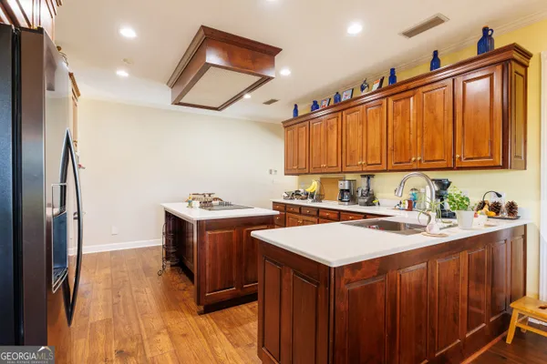 a kitchen with stainless steel appliances granite countertop a sink a stove and a refrigerator