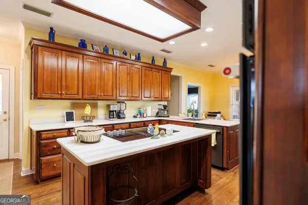 a kitchen with stainless steel appliances granite countertop a sink stove and cabinets