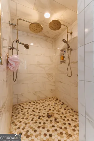 a spacious bathroom with a bathtub a sink and a large mirror