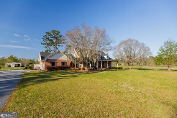 front view of a brick house with a yard