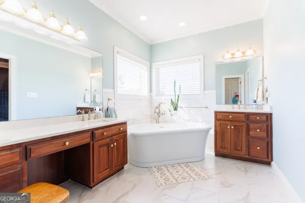 a spacious bathroom with a shower sink and a mirror
