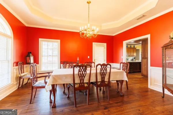 a living room with furniture a fireplace and a chandelier