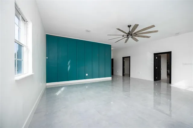 a view of a hallway with wooden cabinet and a living room
