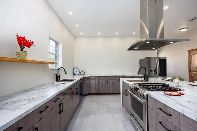 an aerial view of a house with a yard and lake view