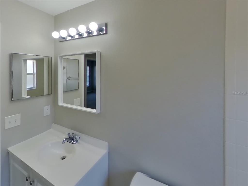 Undisclosed Address Riverview, FL 33578 - Photo 13 of 15 a bathroom with a sink and a mirror