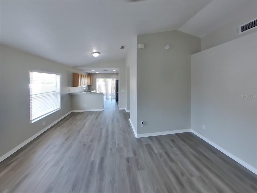 Undisclosed Address Riverview, FL 33578 - Photo 2 of 15 a view of empty room with window and wooden floor