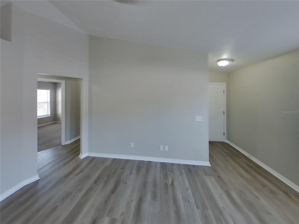 Undisclosed Address Riverview, FL 33578 - Photo 3 of 15 a view of an empty room with wooden floor and a window