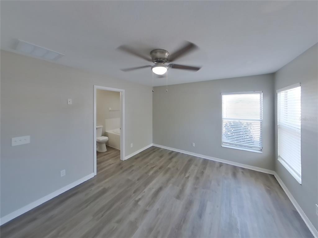 Undisclosed Address Riverview, FL 33578 - Photo 6 of 15 an empty room with wooden floor and windows