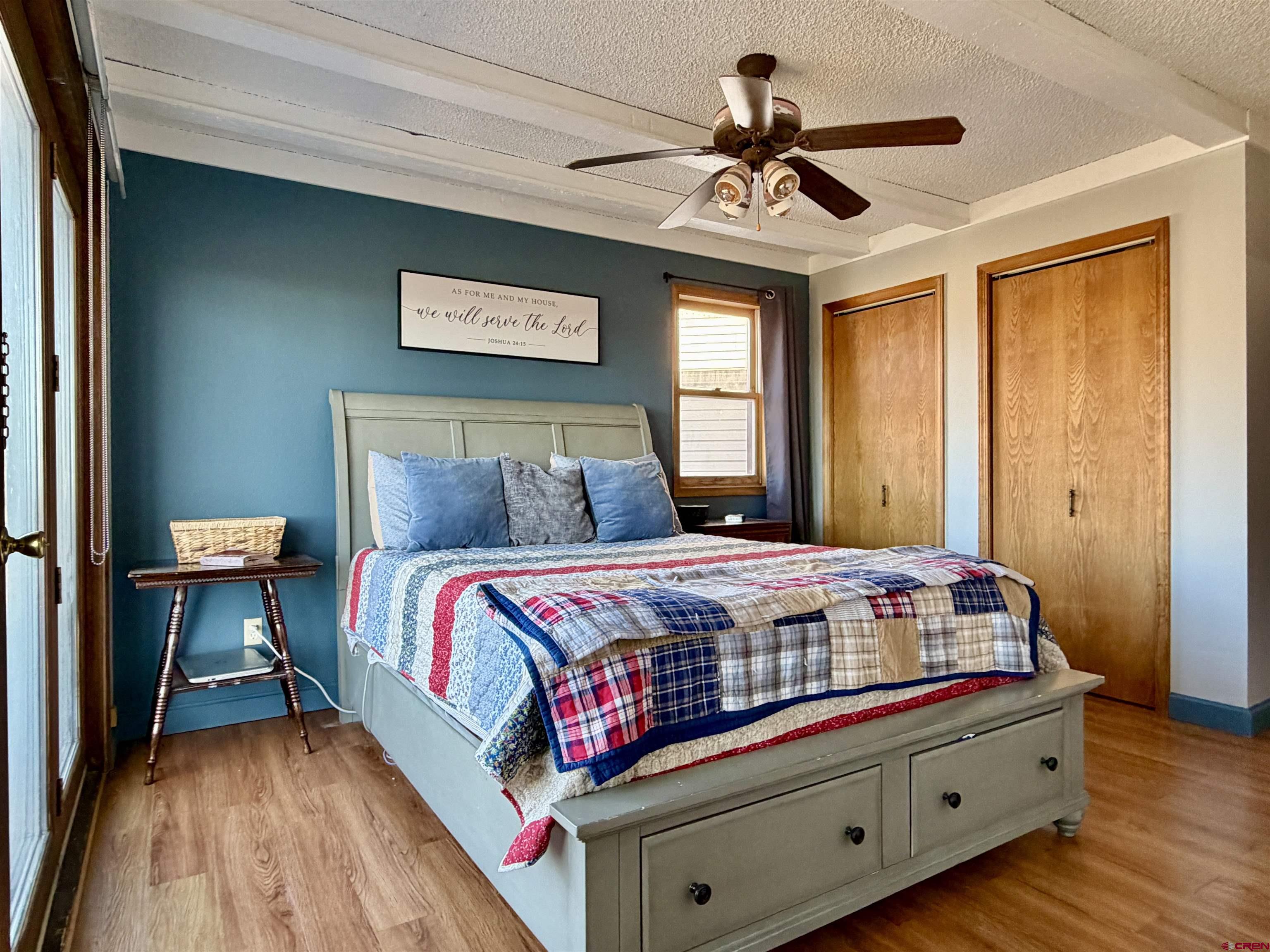 18377 Highway 65 Cedaredge, CO 81413 - Photo 11 of 45 a bedroom with a bed and a chandelier