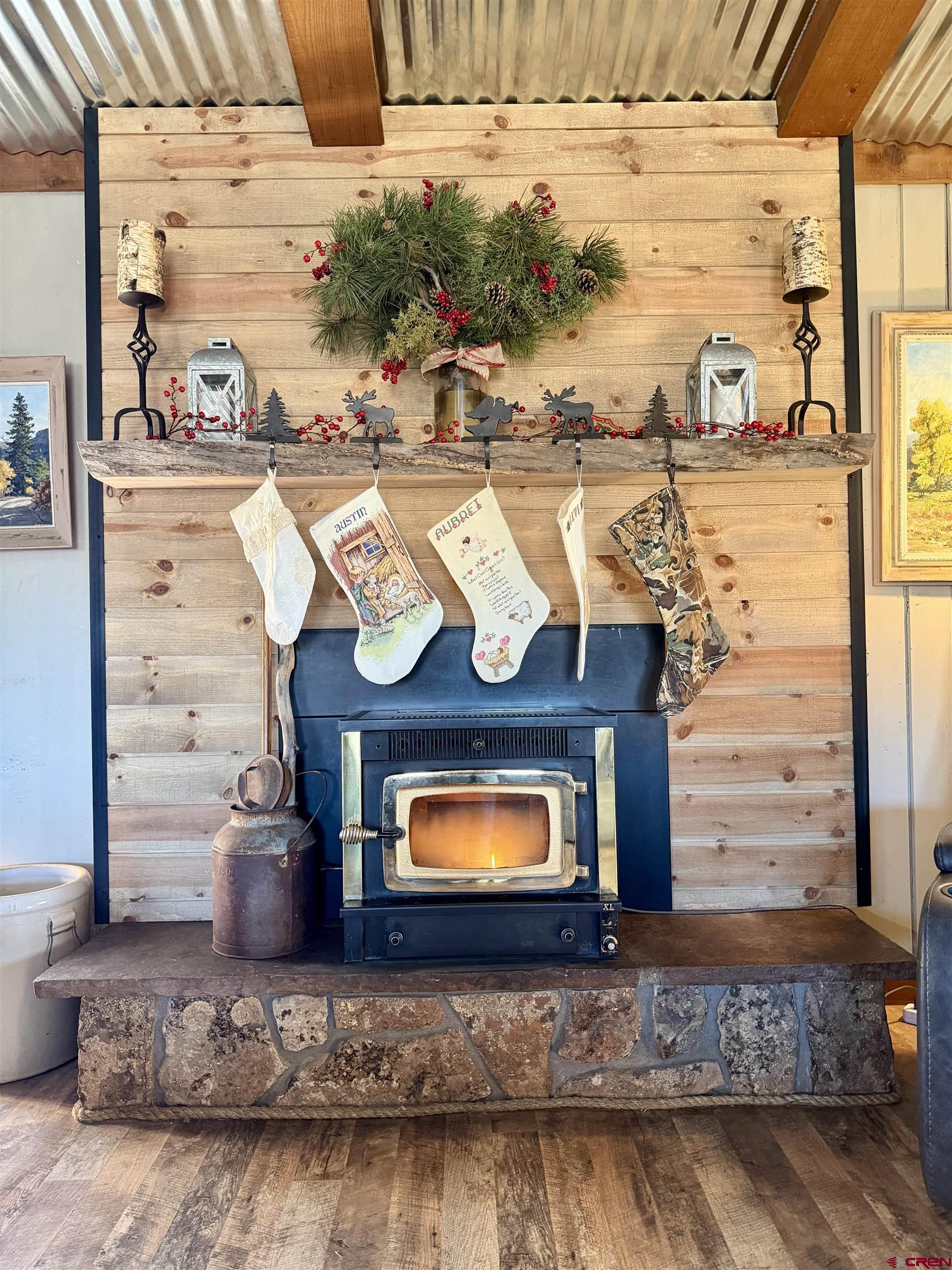 18377 Highway 65 Cedaredge, CO 81413 - Photo 11 of 45 a fireplace with a table and chairs