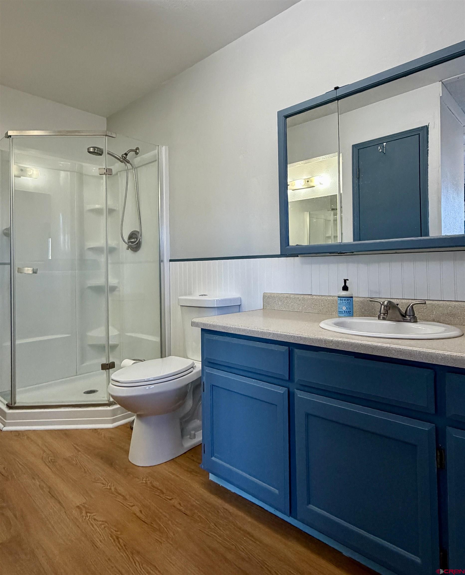 18377 Highway 65 Cedaredge, CO 81413 - Photo 12 of 45 a bathroom with a toilet sink double vanity and shower