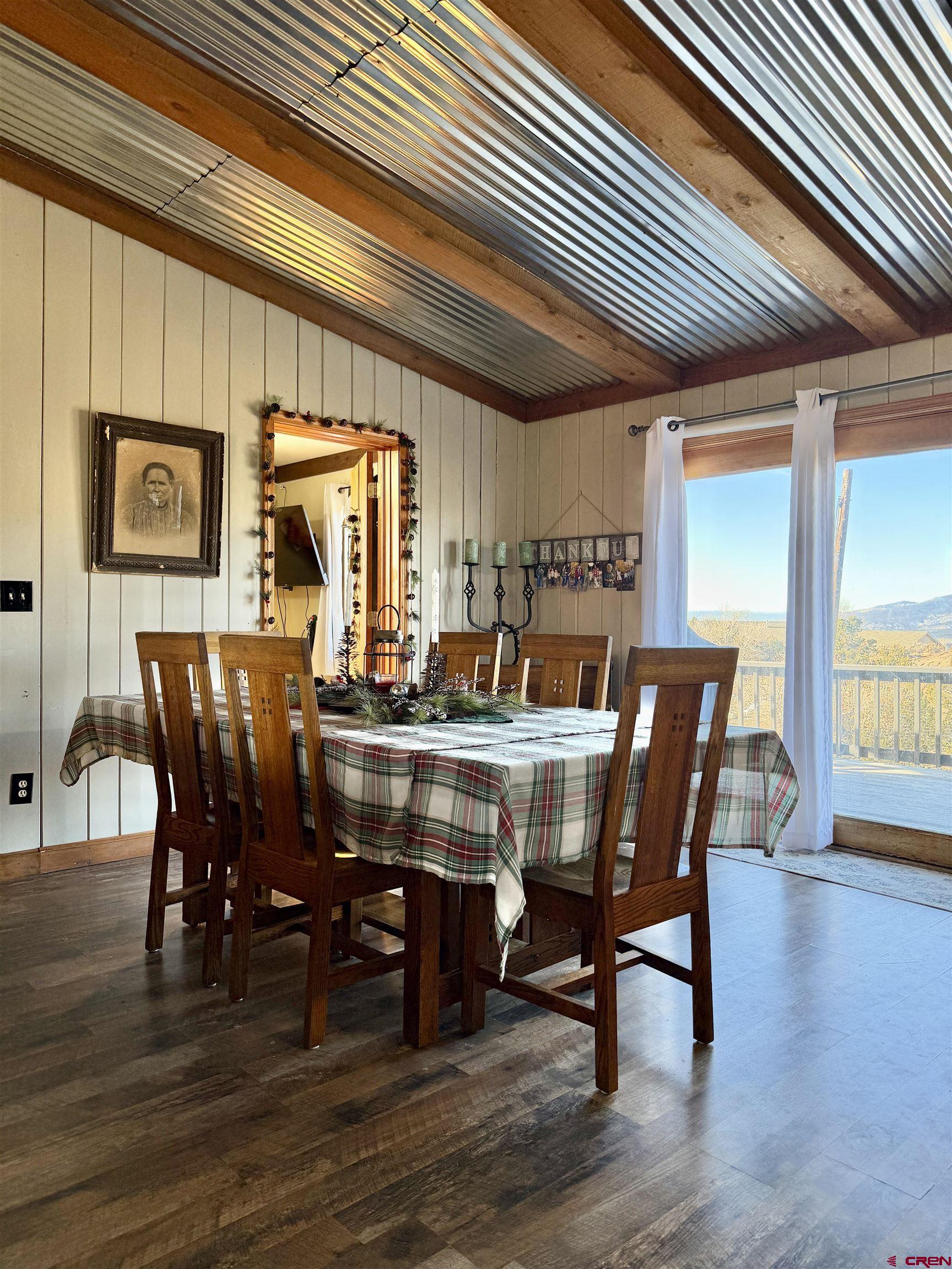18377 Highway 65 Cedaredge, CO 81413 - Photo 16 of 45 a view of a dining room with furniture window and wooden floor