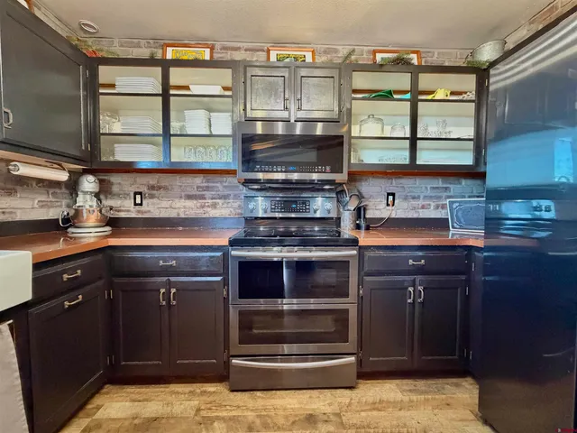 a kitchen with stainless steel appliances granite countertop a stove and a sink