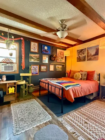 a view of a backyard with a table and chairs under an umbrella