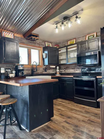 a kitchen with stainless steel appliances granite countertop a sink and cabinets
