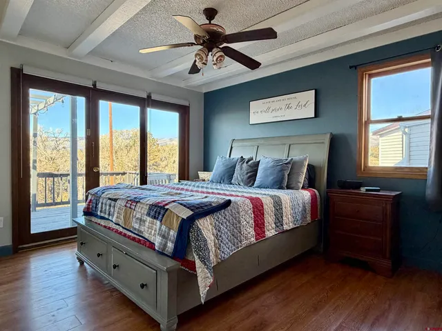 a large bed sitting in a bedroom next to a window