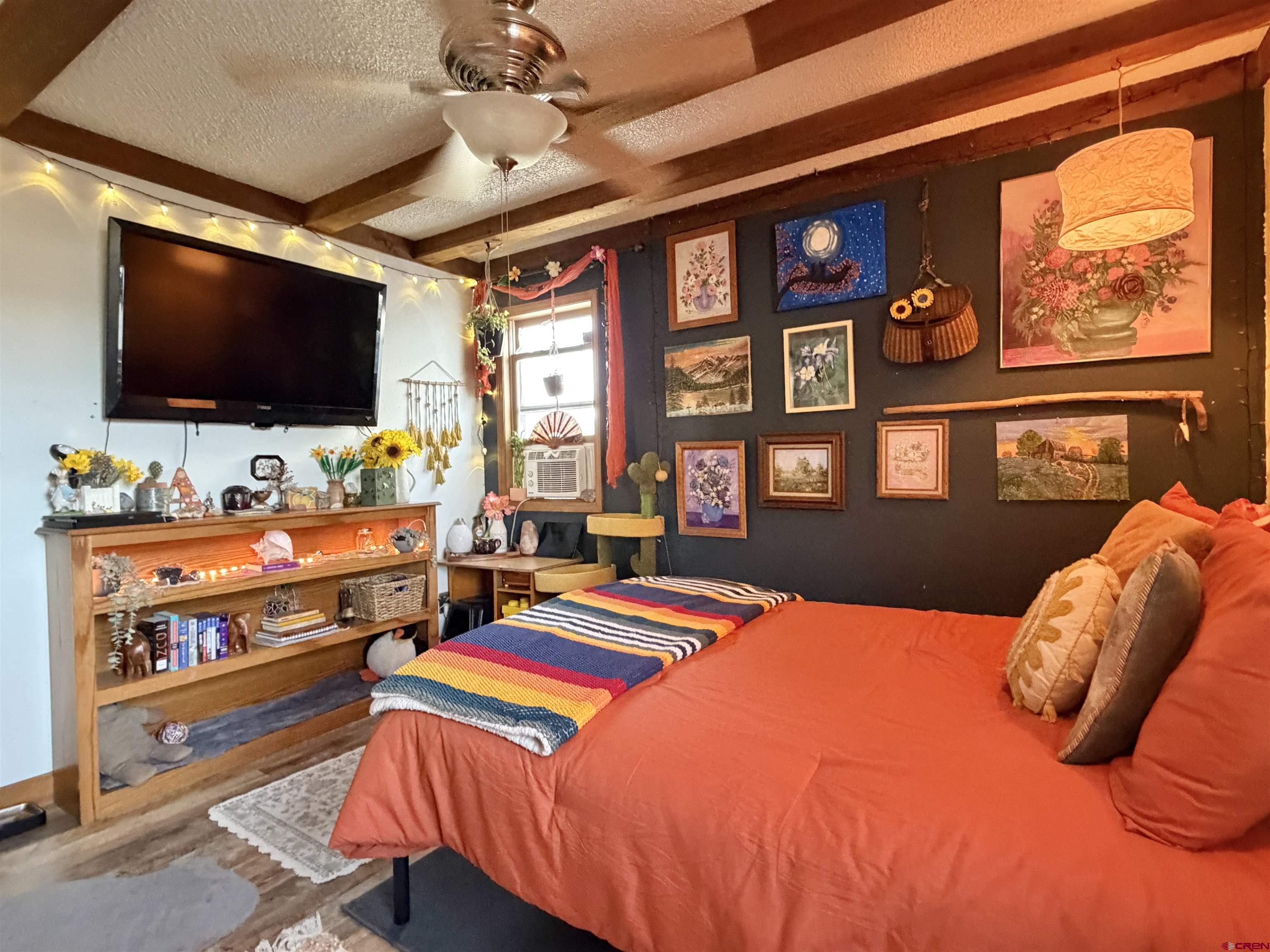 18377 Highway 65 Cedaredge, CO 81413 - Photo 20 of 45 a bedroom with a bed and a flat screen tv