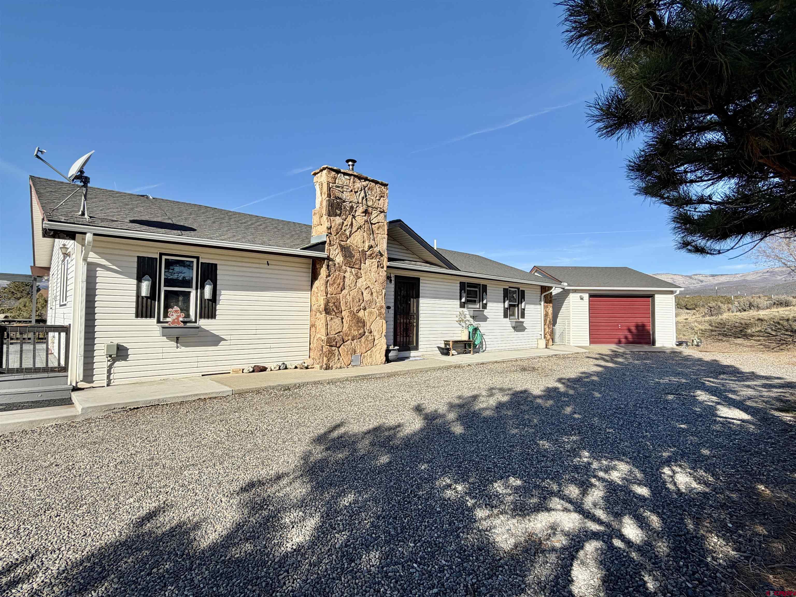 18377 Highway 65 Cedaredge, CO 81413 - Photo 2 of 45 a front view of a house with a yard