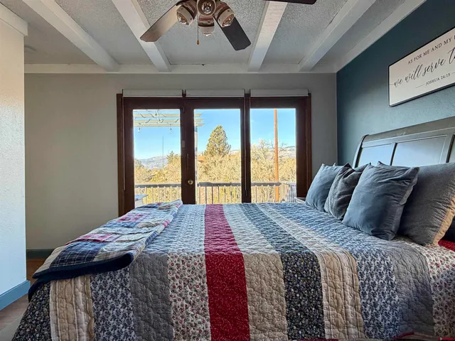 a bed sitting in a bedroom next to a window