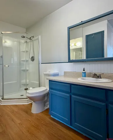 a bathroom with a toilet sink double vanity and shower