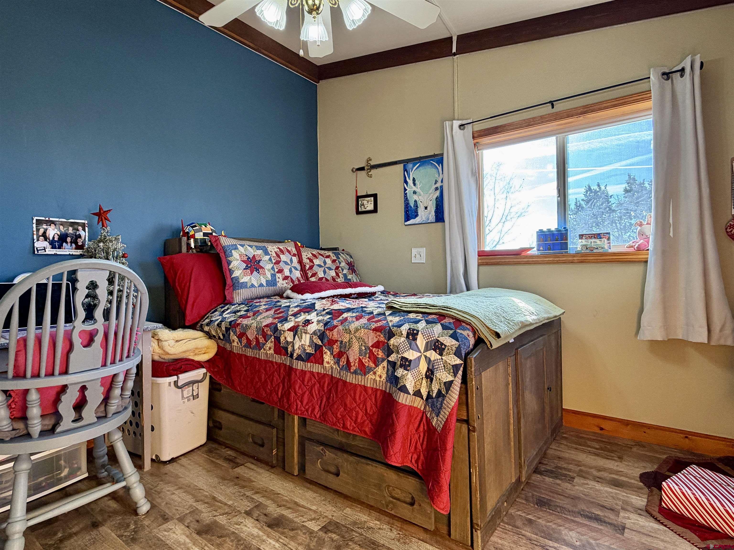 18377 Highway 65 Cedaredge, CO 81413 - Photo 26 of 45 a bedroom with a bed and a window