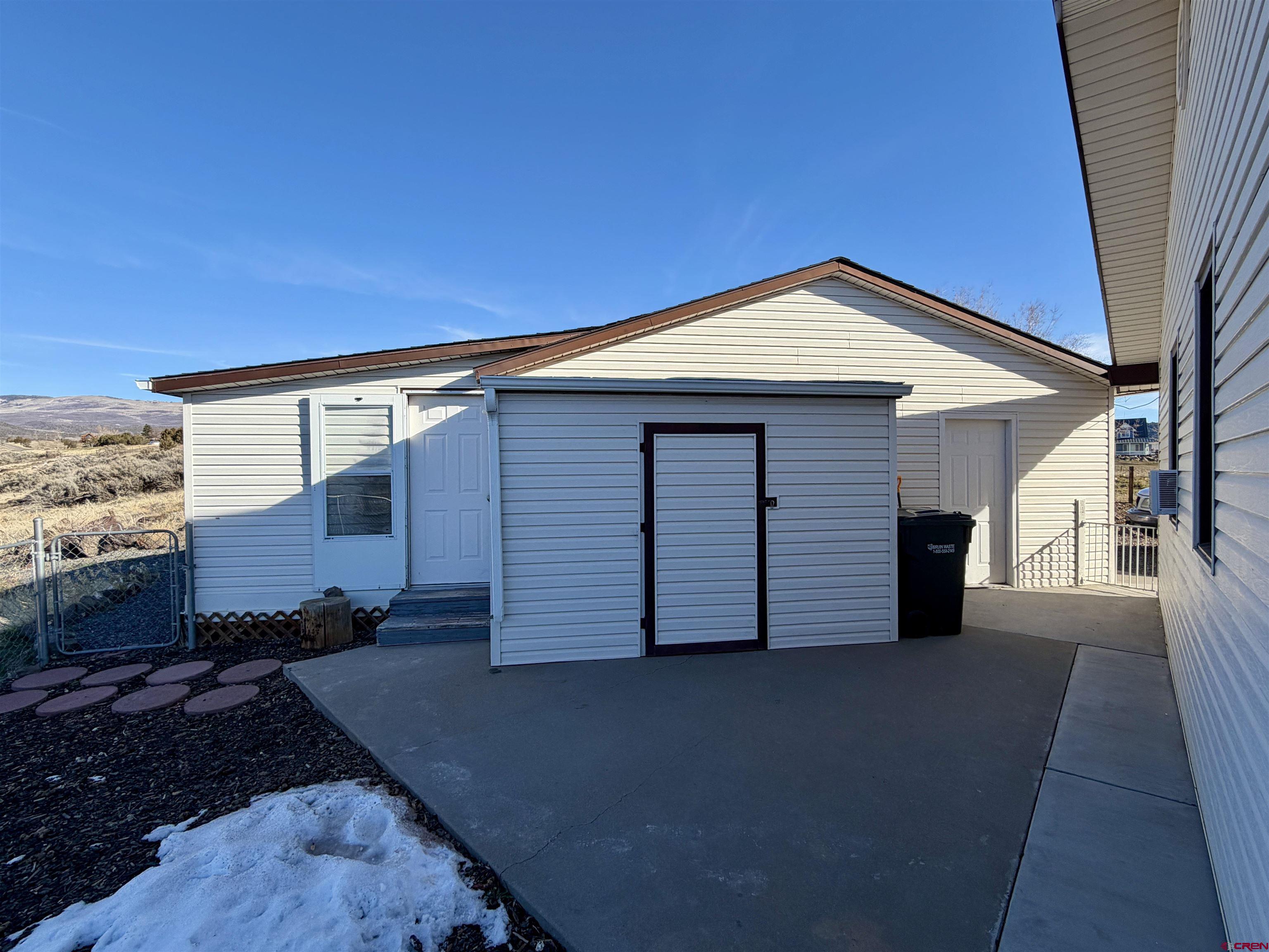 18377 Highway 65 Cedaredge, CO 81413 - Photo 26 of 45 a front view of a house with a yard