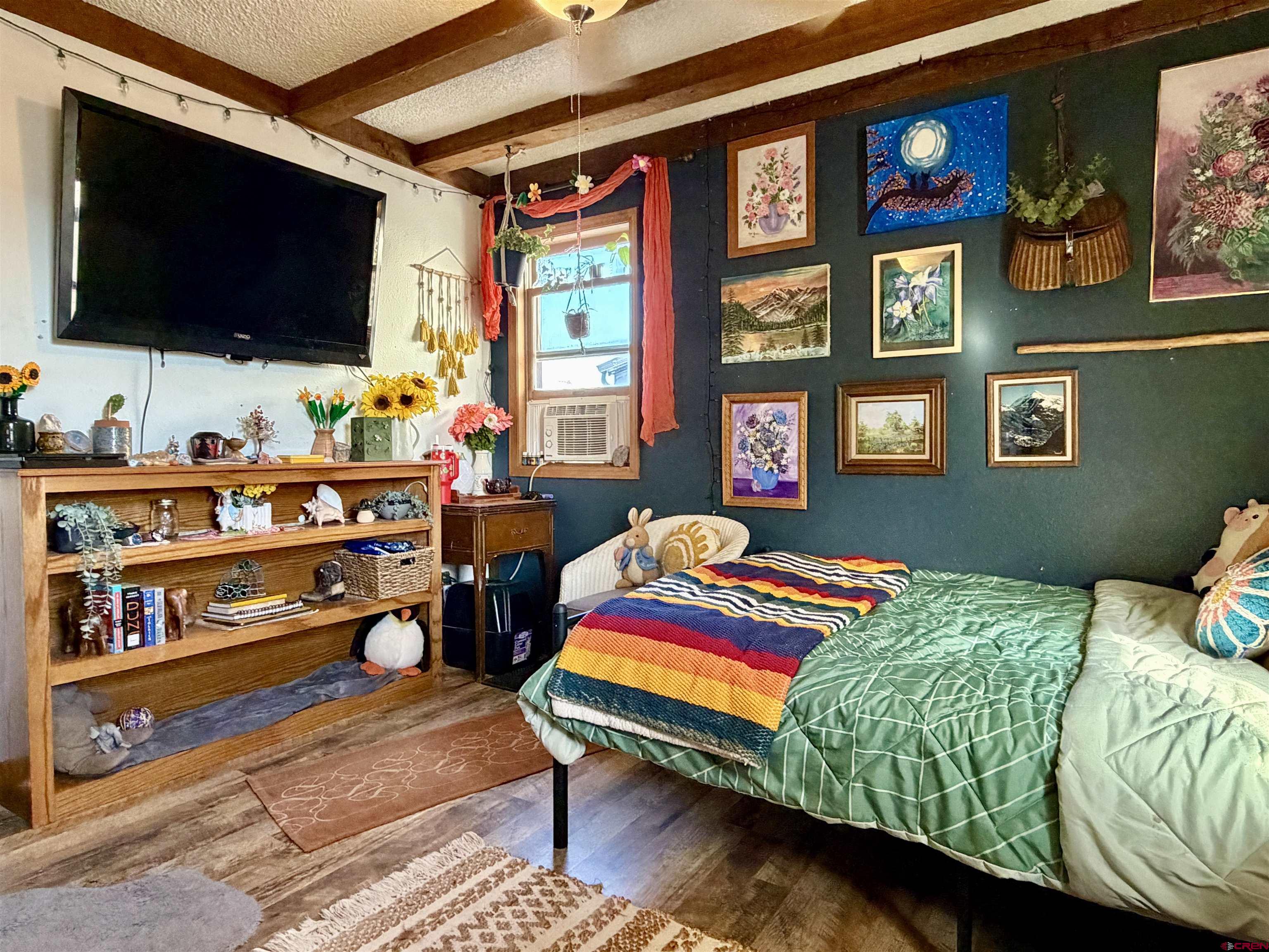 18377 Highway 65 Cedaredge, CO 81413 - Photo 31 of 45 a bedroom with a bed and a flat screen tv