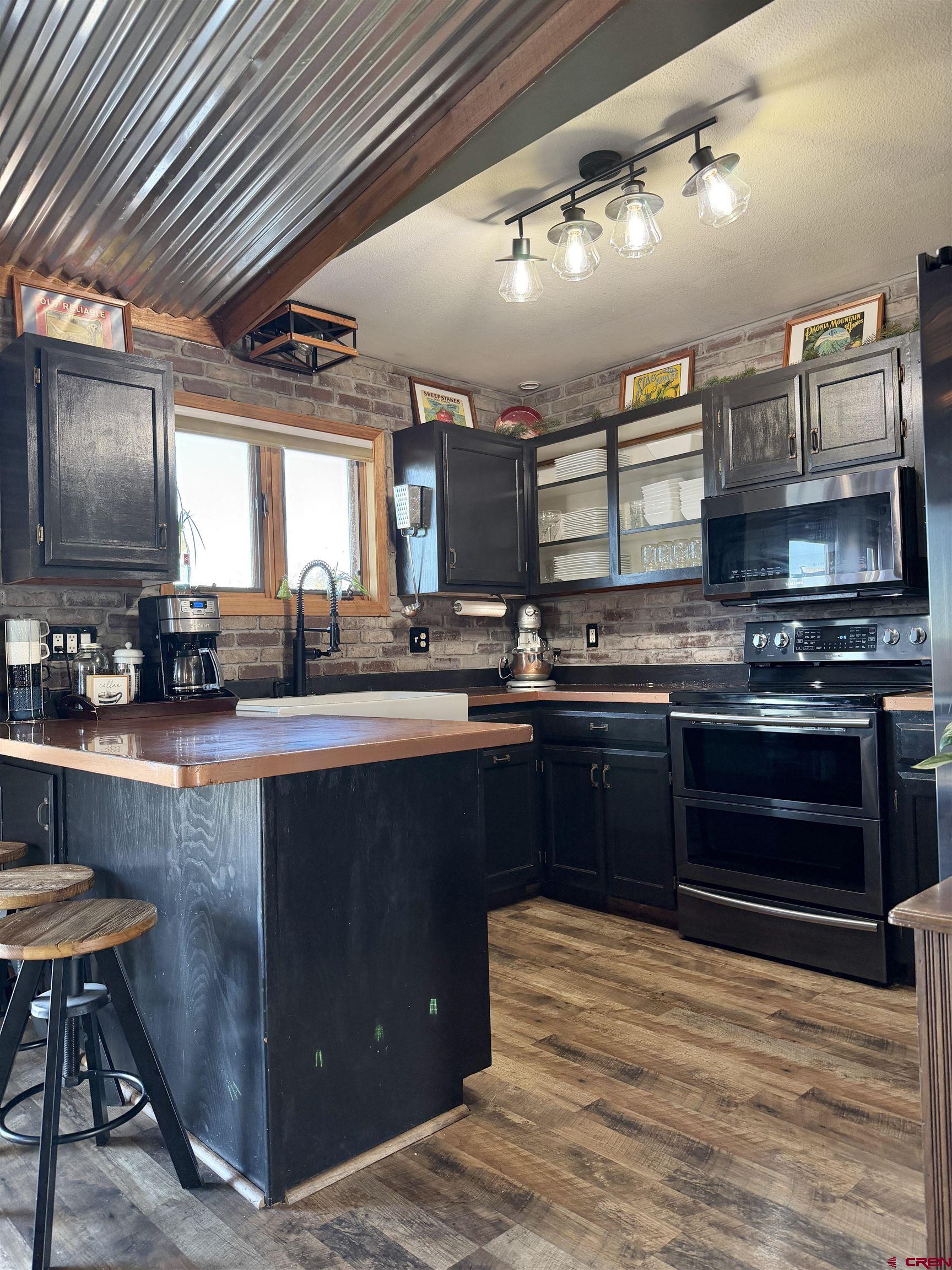 18377 Highway 65 Cedaredge, CO 81413 - Photo 44 of 45 a kitchen with stainless steel appliances granite countertop a sink and cabinets
