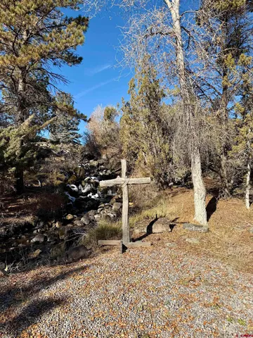 a view of a yard with wooden fence