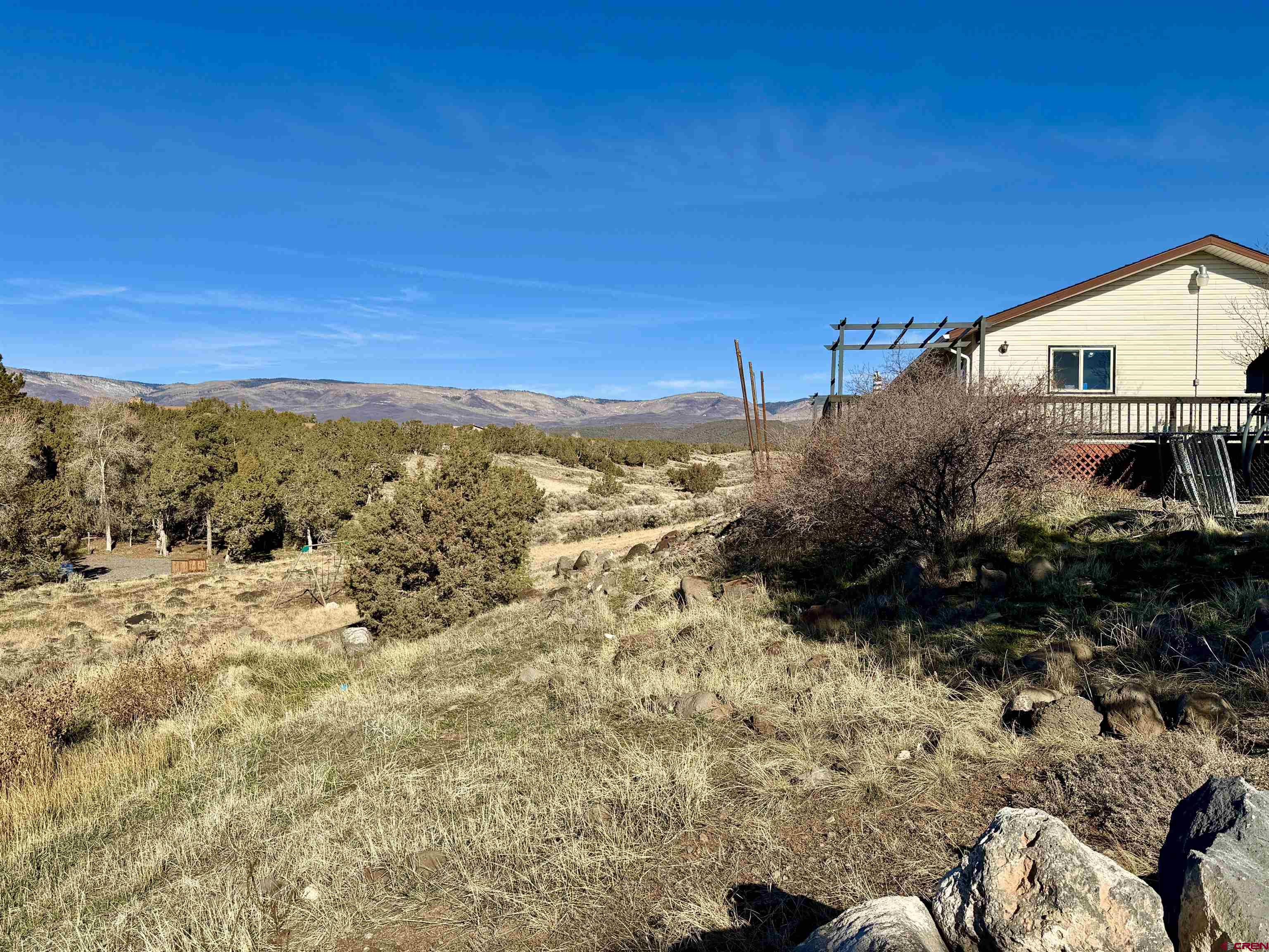 18377 Highway 65 Cedaredge, CO 81413 - Photo 7 of 45 a view of a dry yard with wooden fence
