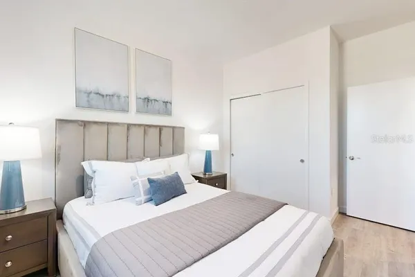 a bedroom with a bed and a night stand