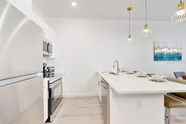 a kitchen with a sink a counter and appliances