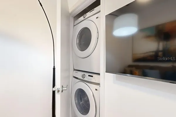 a view of a storage and utility room with washer and dryer