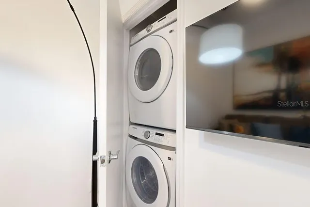 a view of a storage and utility room with washer and dryer