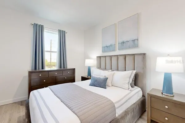 a bedroom with a bed and a window