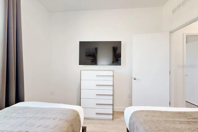 a bedroom with a bed and a television